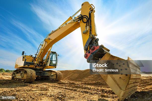 Big Excavator In Front Of The Blue Sky Stock Photo - Download Image Now - Backhoe, Blue, In Front Of