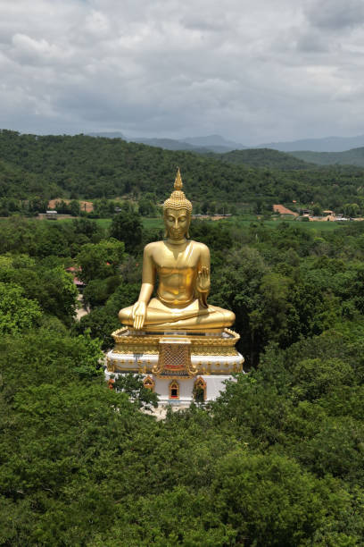 istock Luang Pho To, Wat Pha Thang, is a Buddha image enshrined outdoors in the Prathanphon posture. It is installed prominently and can be observed from a distance. 1647282554