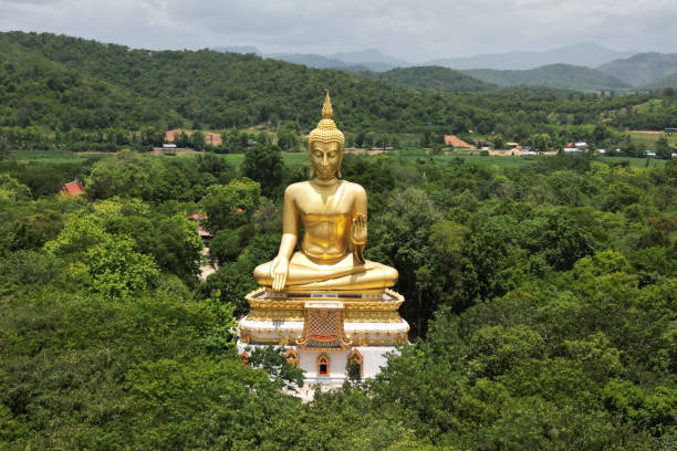 istock Luang Pho To, Wat Pha Thang, is a Buddha image enshrined outdoors in the Prathanphon posture. It is installed prominently and can be observed from a distance. 1647282559