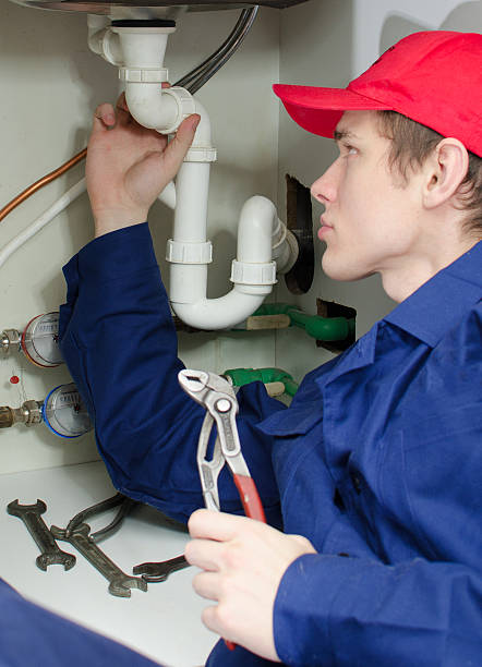 istock Plumber in uniform repairing pipeline 164733170