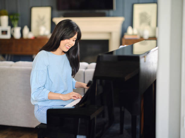 istock Adult Woman Practicing Piano in a Home 1647341984