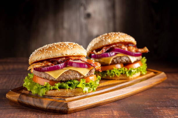 istock Delicious hamburger with meat, cheese, bacon and salad. 1647345615
