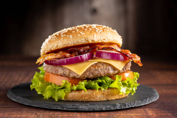 istock Delicious hamburger with meat, cheese, bacon and salad. 1647346124