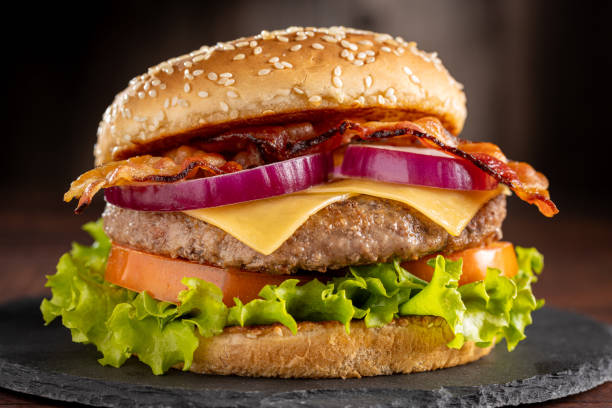 istock Delicious hamburger with meat, cheese, bacon and salad. 1647346128