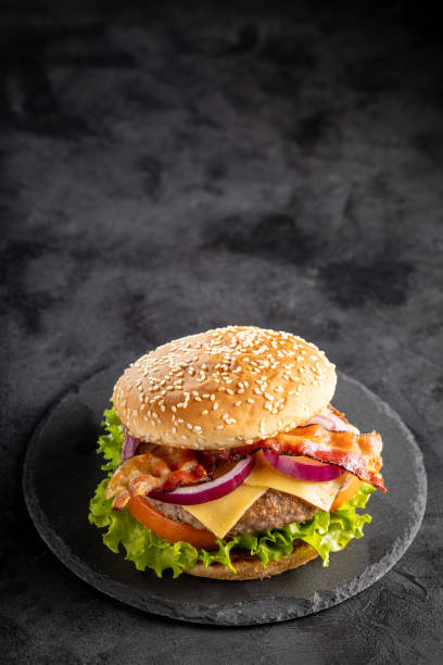 istock Delicious hamburger with meat, cheese, bacon and salad. 1647346634