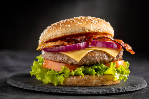 istock Delicious hamburger with meat, cheese, bacon and salad. 1647346635