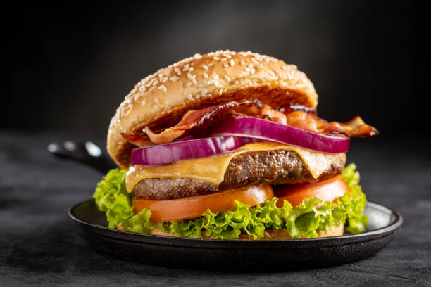 istock Delicious hamburger with meat, cheese, bacon and salad. 1647346646