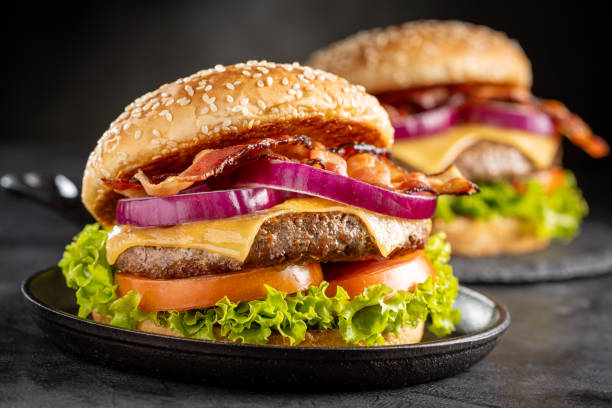 istock Delicious hamburger with meat, cheese, bacon and salad. 1647347150