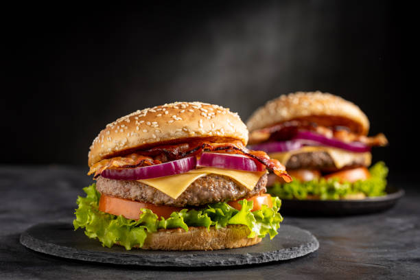 istock Delicious hamburger with meat, cheese, bacon and salad. 1647347161