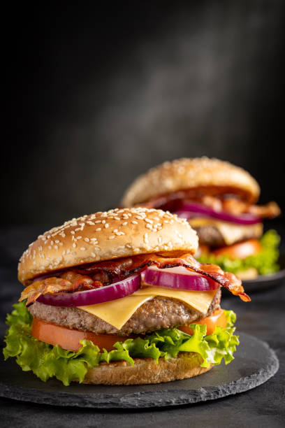 istock Delicious hamburger with meat, cheese, bacon and salad. 1647347162