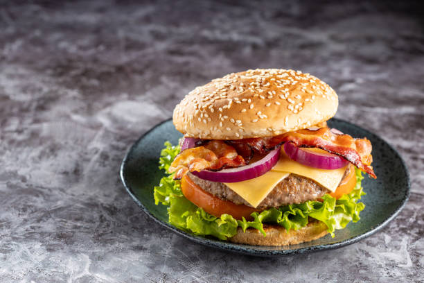 istock Delicious hamburger with meat, cheese, bacon and salad. 1647348697