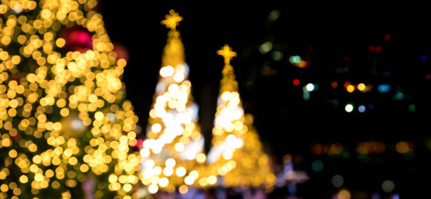 istock Large Christmas tree glowing at city square at night 1647363765