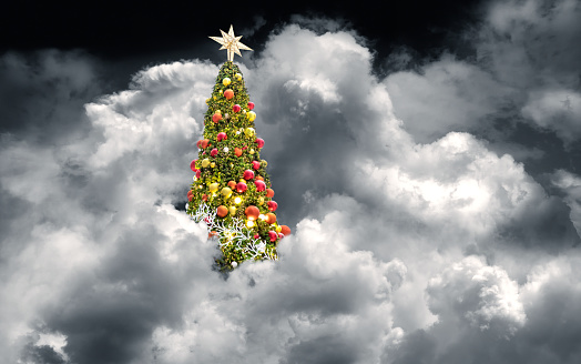 Conceptual decorated shiny Christmas tree in clouds