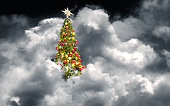 Large decorated Christmas Tree in dramatic sky with storm clouds