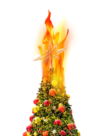 Conceptual burning Christmas tree isolated over white background