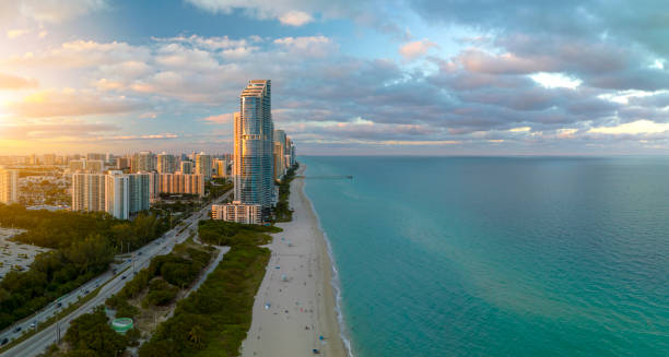 istock Expensive highrise hotels and condos over sandy beachfront on Atlantic ocean shore in Sunny Isles Beach city at sunset. American tourism infrastructure in southern Florida 1647372571