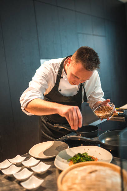 istock Dedicated Young Chef Preparing Gourmet Fare for an Event 1647414350
