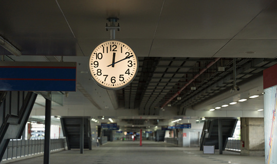 A white clock of Sky train station to tell the people who use the station to know the goodbye time.