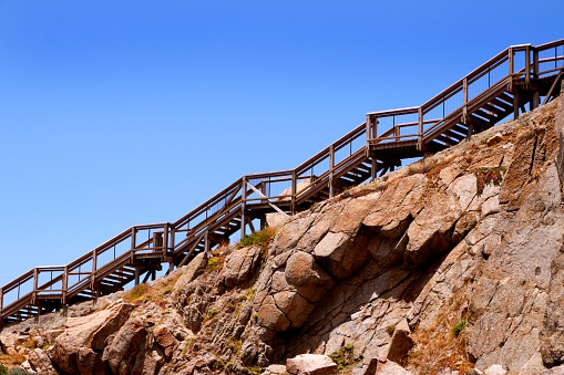 A staircase climbs the sheer rockface of the cliff on Granite Island near Victor Harbor, South Australia