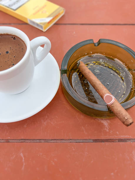 istock cup of coffee and cigar on table 1647482490