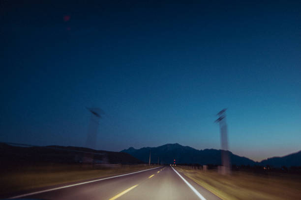 The open road blurs past at blue hour. in United States, Idaho, Mackay