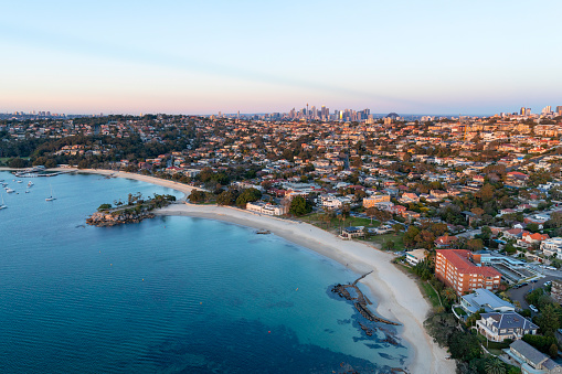 Aerial view of Balmoral Beach, Sydney on sunrise looking into the city of Sydney.