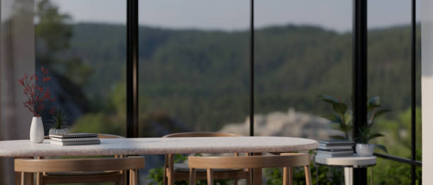 istock Mockup space on a dining table in a modern dining room with a large glass wall window 1647550466