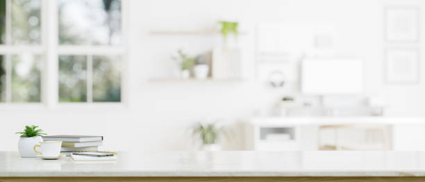 istock Mockup space on a tabletop with a blurred white home office or working room in the background 1647550467