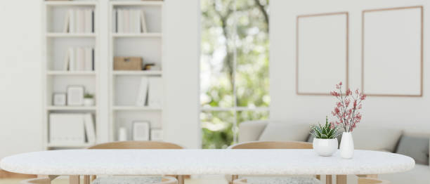 istock Copy space on a white dining table with a blurred modern Scandinavian white living room 1647553141