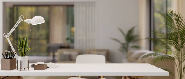 istock Copy space on a white table with a blurred modern living room in the background. 1647553143