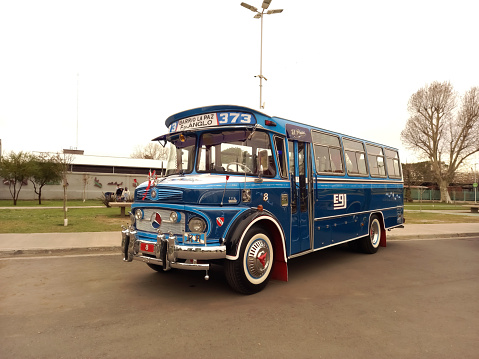 Avellaneda, Argentina - Aug 20, 2023: Old blue 1980s Mercedes Benz 1114 bus in the street. Public passenger transport in Buenos Aires. Line 373. Traditional fileteado ornaments. Copy space