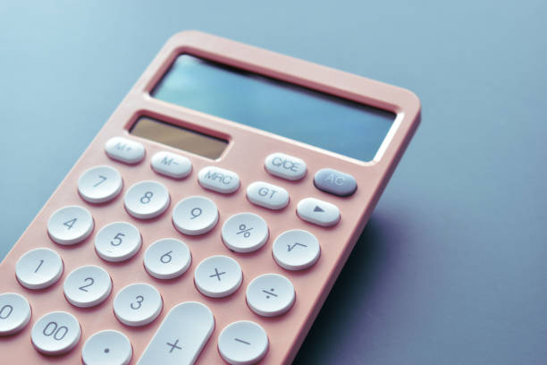 istock close up modern peach colour pastel calculator and white button on blue background, business and finance accounting concept 1647596513