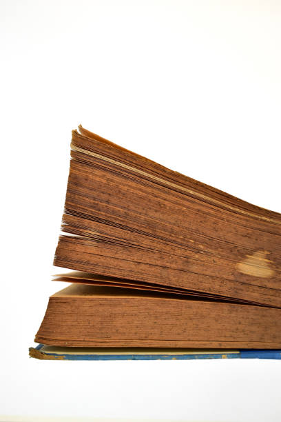 istock close up brown old book isolated on white background, vintage style 1647597049