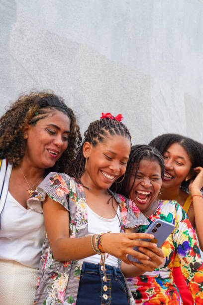 istock Multicultural friends taking a selfie picture with a cell phone outside 1647638611
