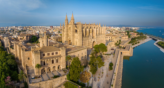 Palma de Mallorca Cityscape Aerial Drone Point of View. Looking towards the Palma de Majorca Cityscape with iconic Cathedral of Santa Maria of Palma - La Seu in the Panorama Center. Waterfront Promenade and old town houses. Cathedral of Palma, Palma de Mallorca, Majorca Island, Balearic Islands, Catalonia, Spain, Southern Europe.