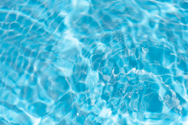 istock Blue water with ripples on the surface. Defocus blurred transparent blue colored clear calm water surface texture with splashes and bubbles. Water waves with shining pattern texture background. 1647646978