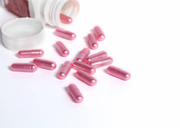 istock gray and pink pill capsules on a white background 1647668185