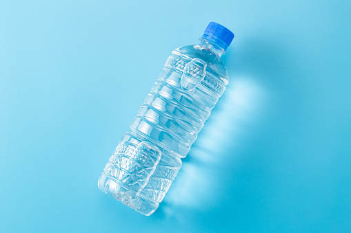 Bottled water on blue background.