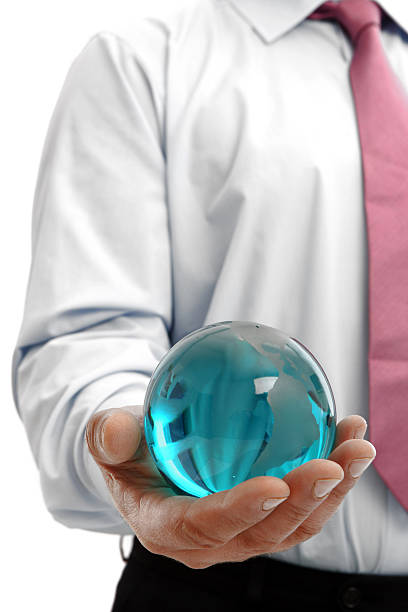 istock Man in white shirt holding blue glass globe in his hand 164768926