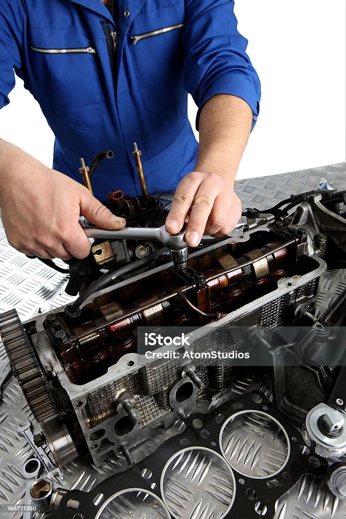 Mechanics hands Mechanic repairing car engine.  the head gasket is visible in foreground. (shot using Canon Eos 1ds mark III) Adjustable Wrench Stock Photo