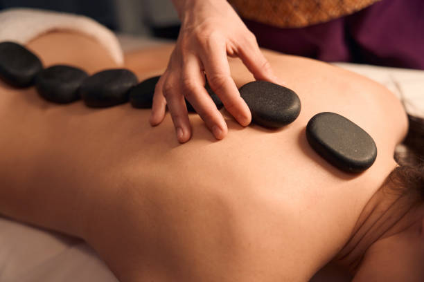 istock Spa therapist relieving female patient of backache during massotherapy session 1647731286