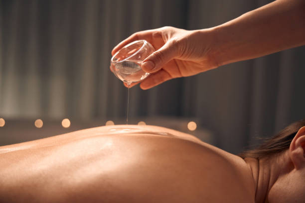 istock Beauty clinic masseuse preparing client for body massage 1647731328