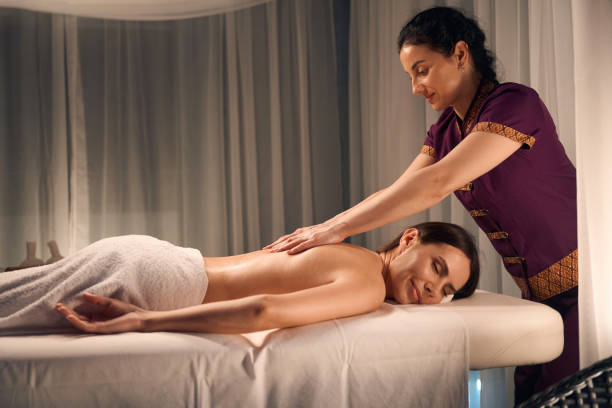 istock Wellness center masseuse giving relaxing back massage to client 1647731362