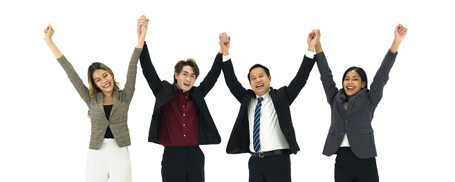 Group of asian business people wearing suit raise hands together, feeling happy and smiling, completed finished job. Successful team and team building concept.