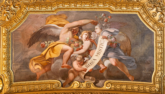 Genova - The baroque fresco of angels with the marianic inscipition in the church Basilica di Santa Maria delle Vigne from 19. cent.