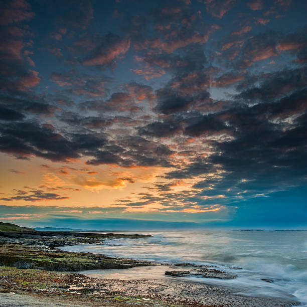 Sunset over Bamburgh Beach, Northumberland stock photo