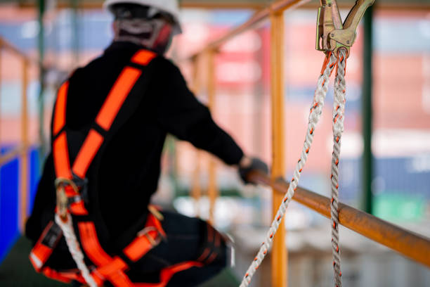 istock Construction worker wearing safety harness working at high place 1647783030