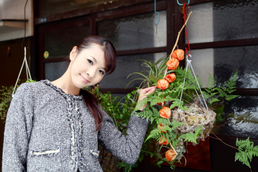 Beautiful Japanese woman with house plants.  iStockalypse Tokyo, Japan 2010.