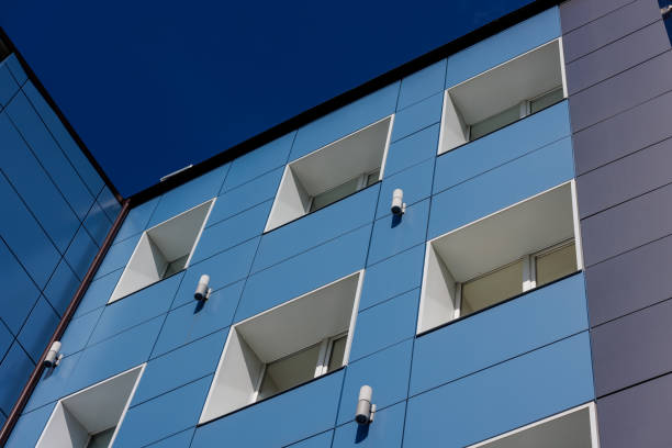 istock generic blue office building wall with windows and composite aliminium panels, diagonal upward view 1647788455