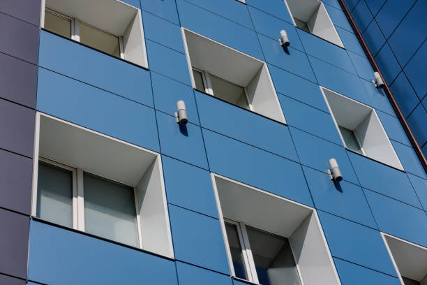 generic blue office building wall with windows and composite aliminium panels, diagonal upward view